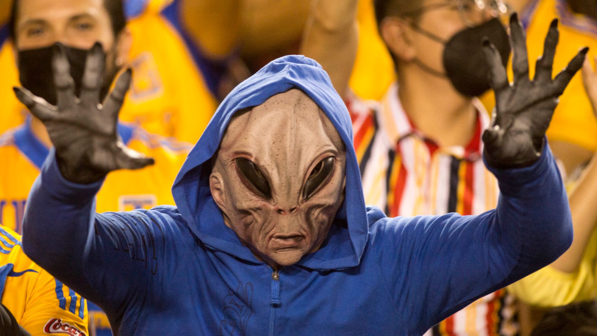 A Tigres fan dressed as an alien cheers during the Mexican Apertura 2021 football match between Guadalajara and Tigres at the Universitario stadium in Monterrey, Mexico, on October 30, 2021. (Photo by Julio Cesar AGUILAR / AFP) (Photo by JULIO CESAR AGUILAR/AFP via Getty Images) 