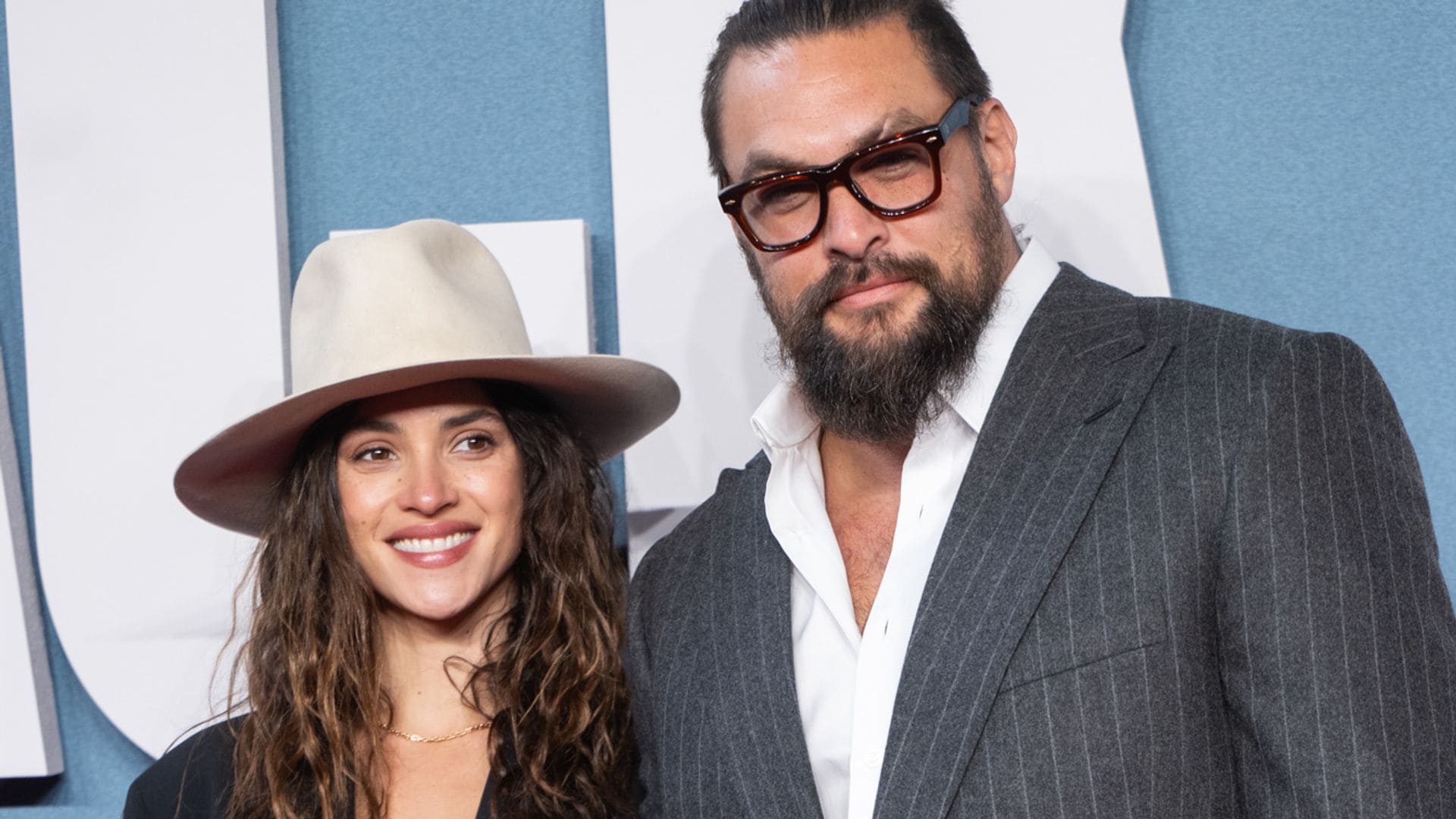 Adria Arjona takes the wheel with Jason Momoa ahead of their getaway— is it an anniversary trip?