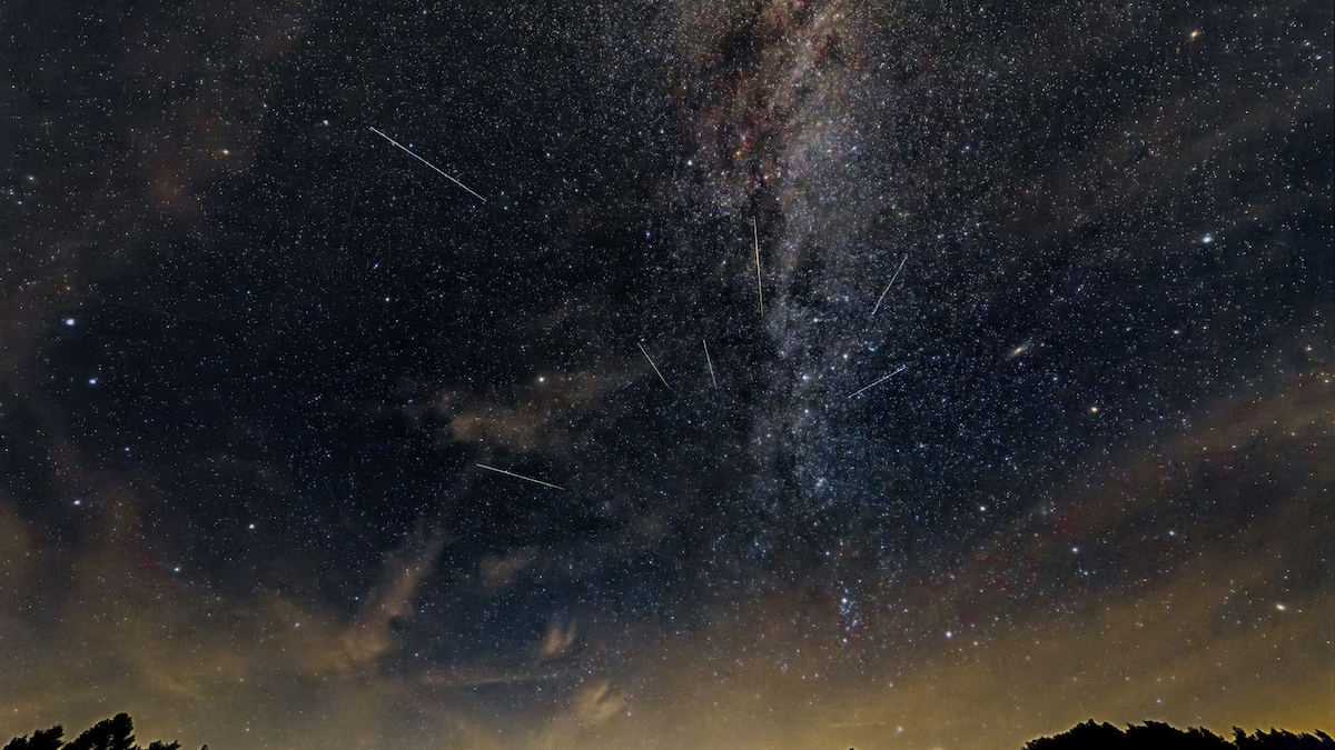 https://www.hola.com/us/horizon/landscape/7e2b81711d1d-an-impressive-night-sky-with-the-milky-way-and-shooting-stars-over-a-silhouetted.jpg?im=Resize=(1200)