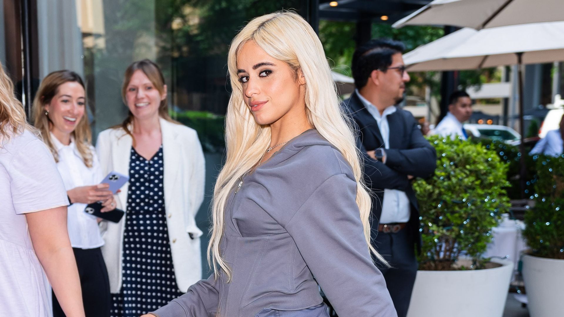 Camila Cabello looks stunning in gray shorts and knee high boots