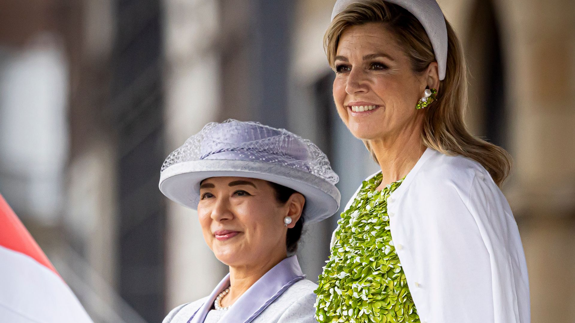 Queen Máxima shines in bold green dress with floral appliqués while Empress Masako opts for silk skirt suit and matching gloves