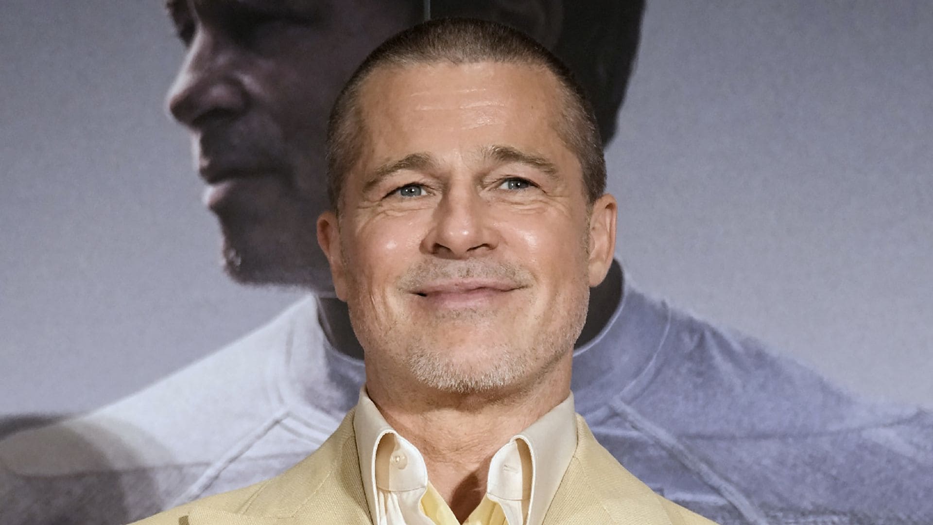 This photo taken on June 25, 2025 shows US actor Brad Pitt smiling on stage as he attends an event for his latest film "F1: The Movie", in Tokyo.