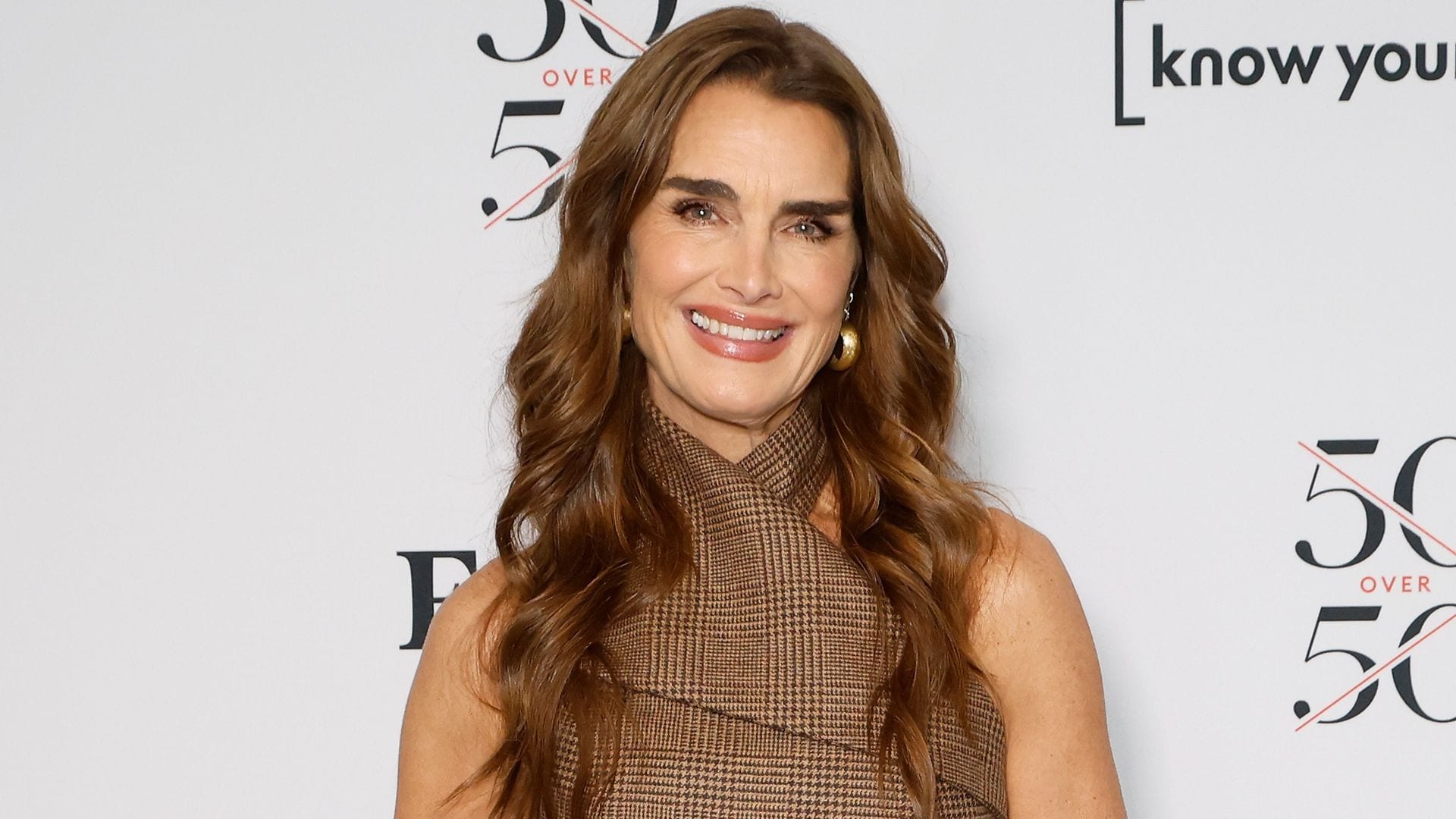 Brooke Shields is all smiles posing in fishnet top and micro-shorts