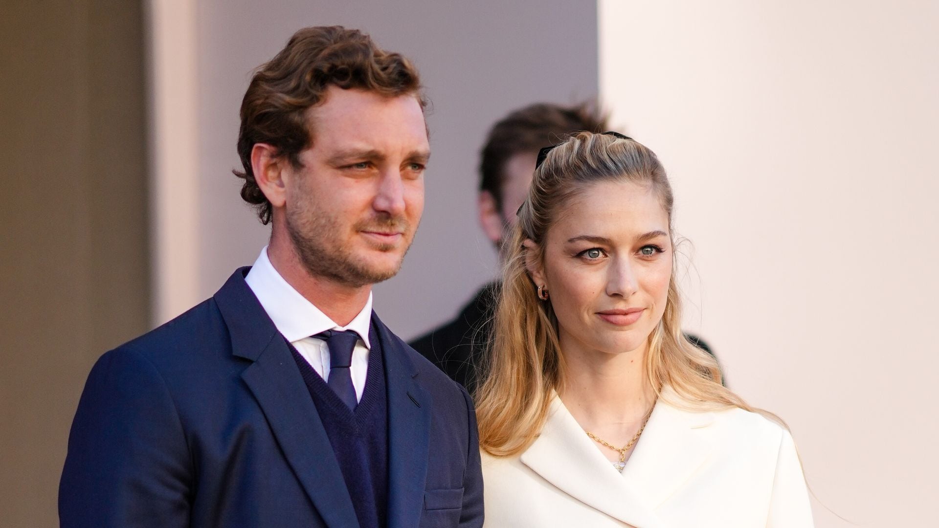  Pierre Casiraghi (L) wears a white shirt, a navy blue tie, a navy blue wool V-neck pullover, a navy blue blazer jacket, ; Beatrice Borromeo (R) wears earrings, a gold chain pendant necklace, a white t-shirt, a white latte buttoned jacket, outside Dior during Paris Fashion Week
