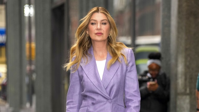Ellen Pompeo walks in New York City wearing a lavender suit with matching heels and a white top.