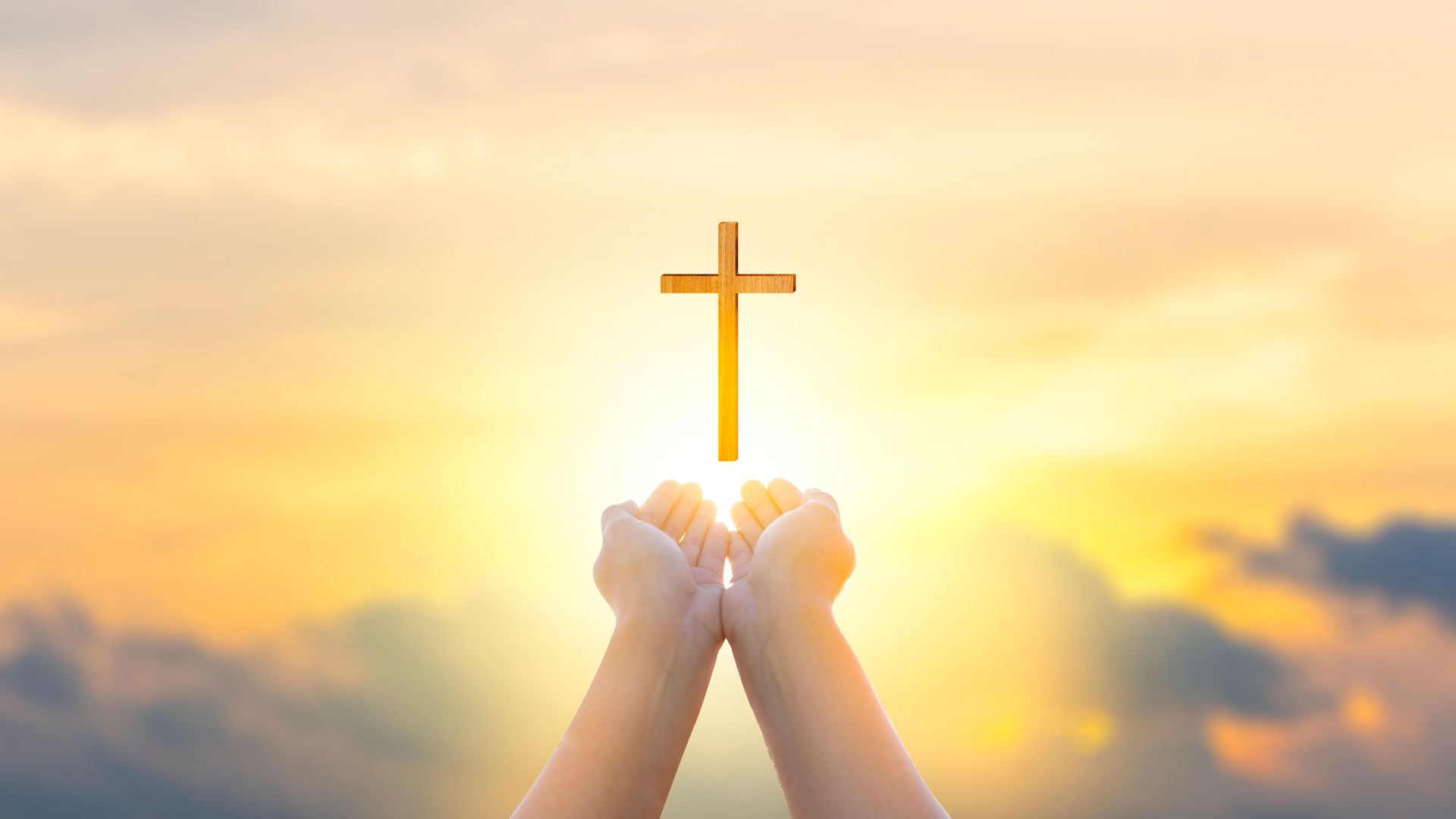 Religion Christ and the cross of Jesus Christ at sunset, golden light. 