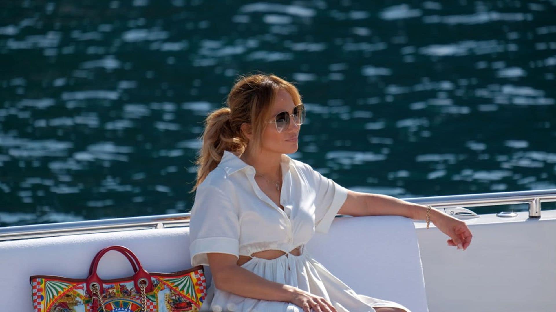 Jennifer Lopez glowed in bronzy makeup and a neon sweater dress