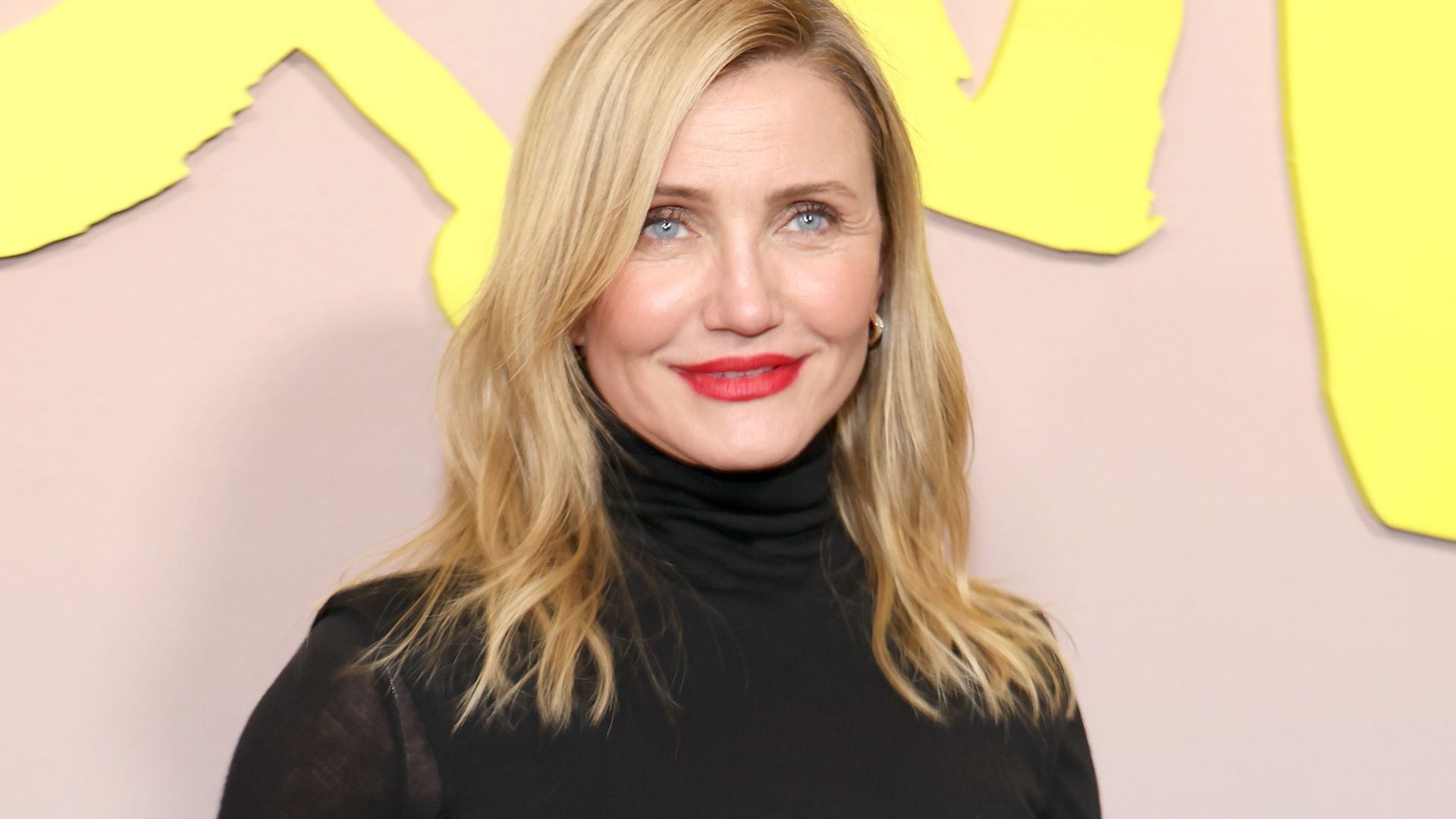 Cameron Diaz turns heads in sleek black look and bold red lip as she steps back into the spotlight