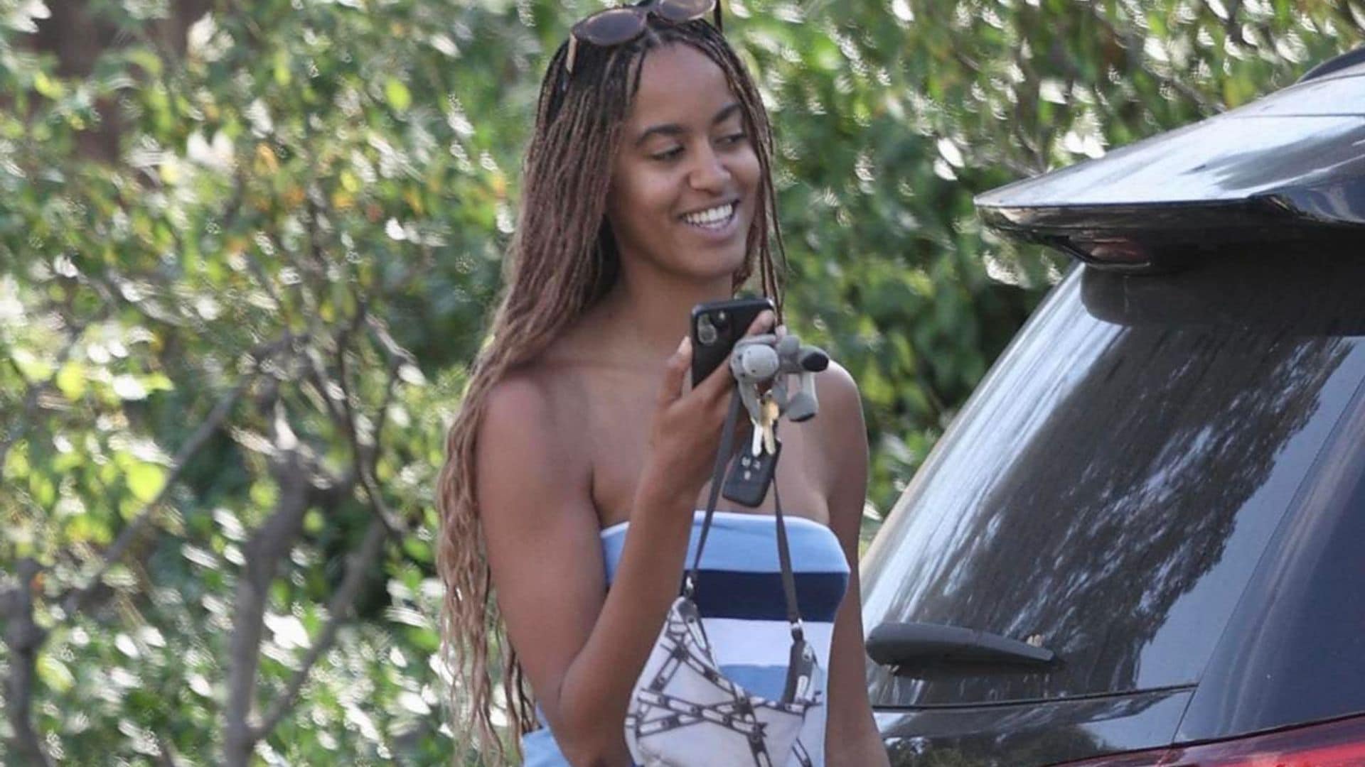 Malia Obama channels 2000s fashion in strapless blue mini dress and chunky boots
