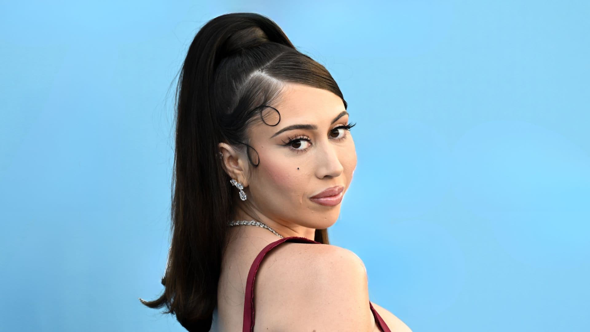 Kali Uchis carries her baby while taking a dip in Miami Beach
