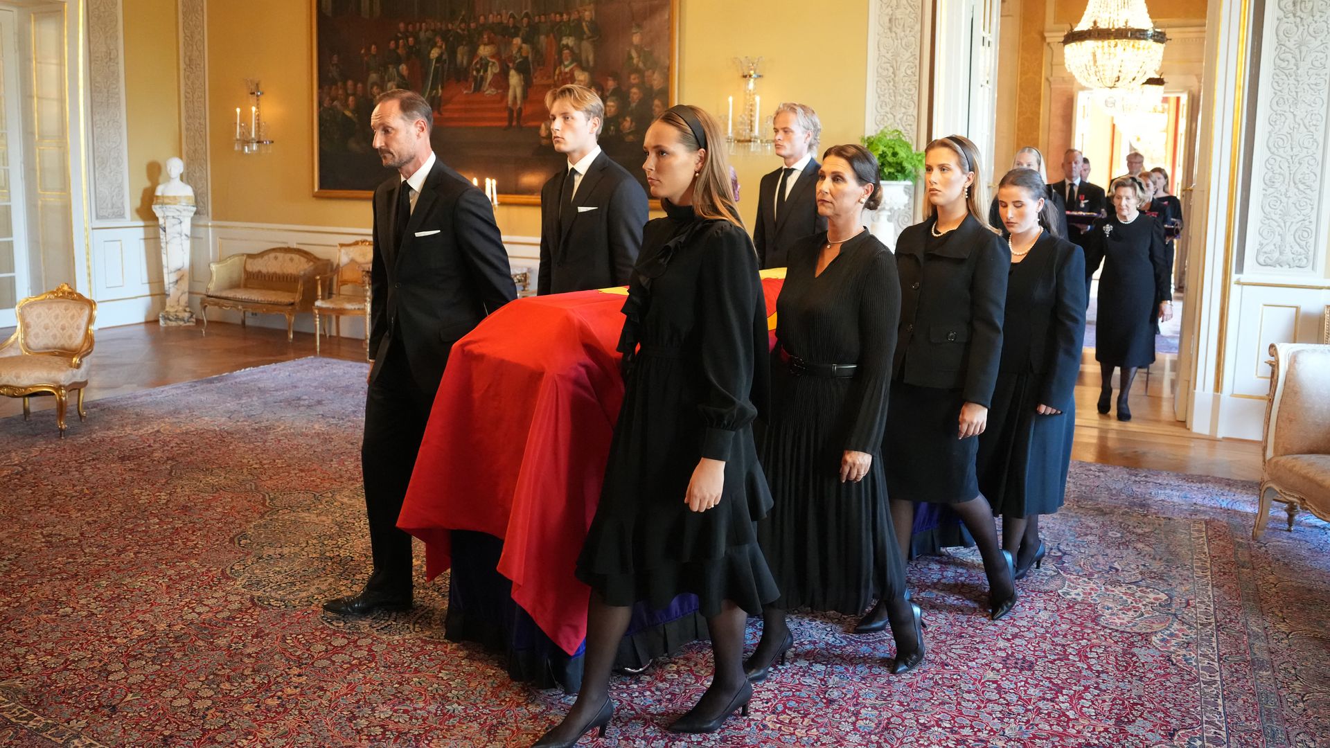 The coffin of King Harald V of Norway moved from the Red Salon to the Palace Chapel in Oslo. Borg is in the back, helping carry the load.