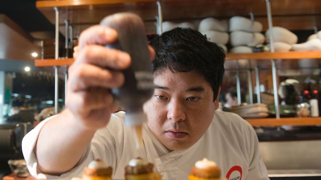 Peruvian Nikkei chef Mitsuharu Tsumura, known as Misho, places the final touches on a dish of his creation at the Maido high-cuisine restaurant in Lima on June 17, 2016.