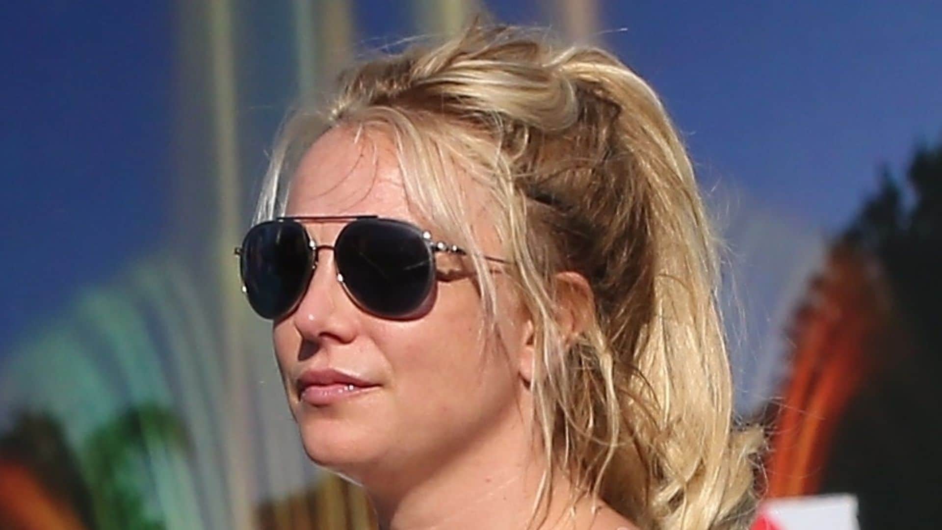 Pop superstar, Britney Spears and her boyfriend Sam Asghari seem inseparable after enjoying dinner at Le Pain in Beverly Hills. Britney, who dons a sheer white blouse that reveals her breasts, seems to be holding on tight to her man's biceps as the couple crosses the street together.