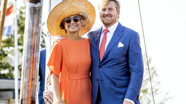 Queen Maxima rides bike in dress and heels