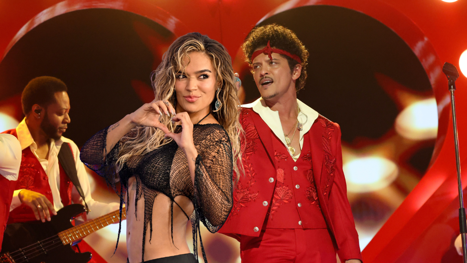 Karol G teams up with Bruno Mars on "Still," her first full English-language performance, featured on her emotional new album No Me Arrepiento De Sentir Tanto.

