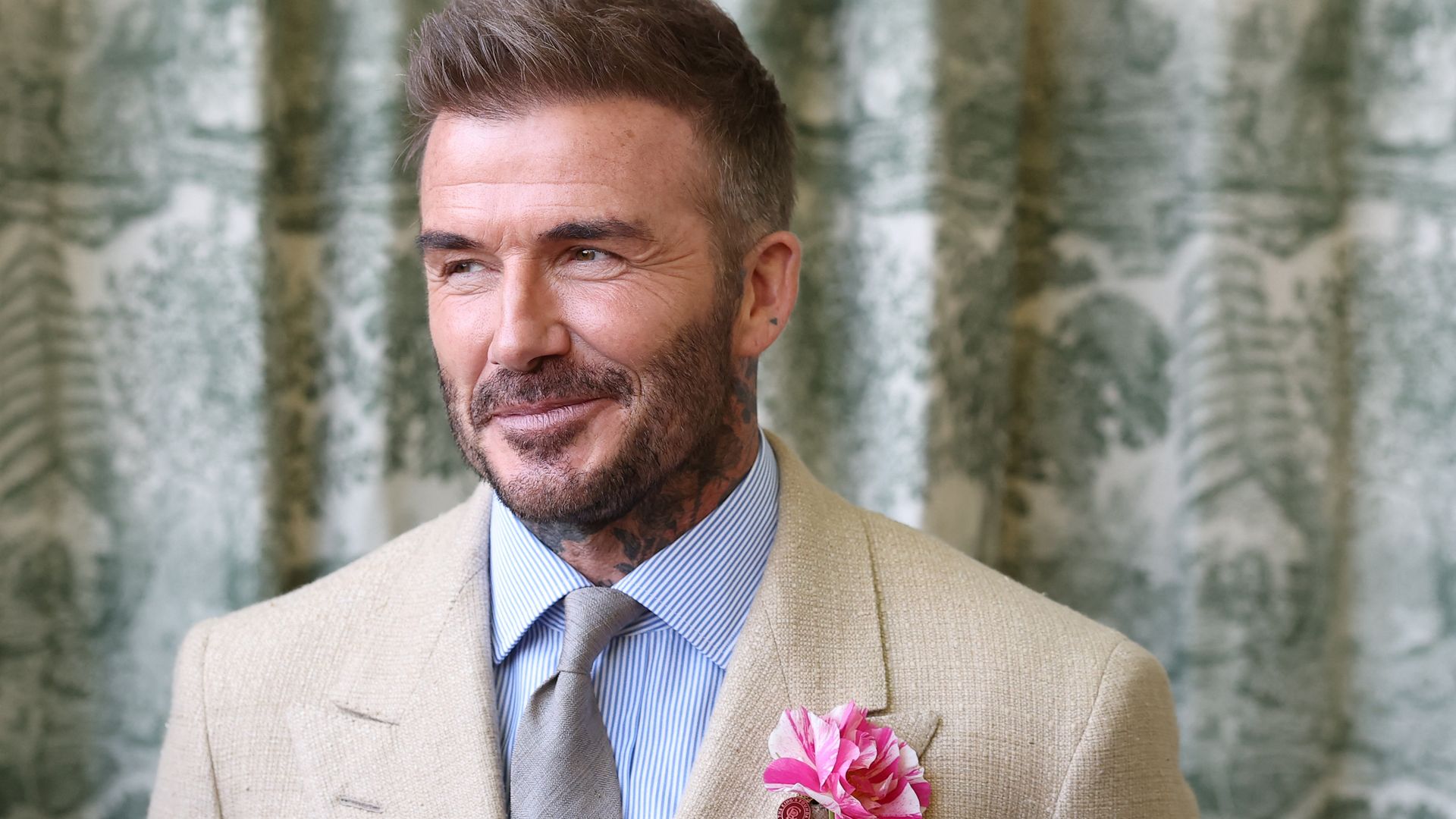 David Beckham wearing a David Austin Roses "King's Rose" waits to meet the King during a visit to the RHS Chelsea Flower Show at Royal Hospital Chelsea on May 20, 2025