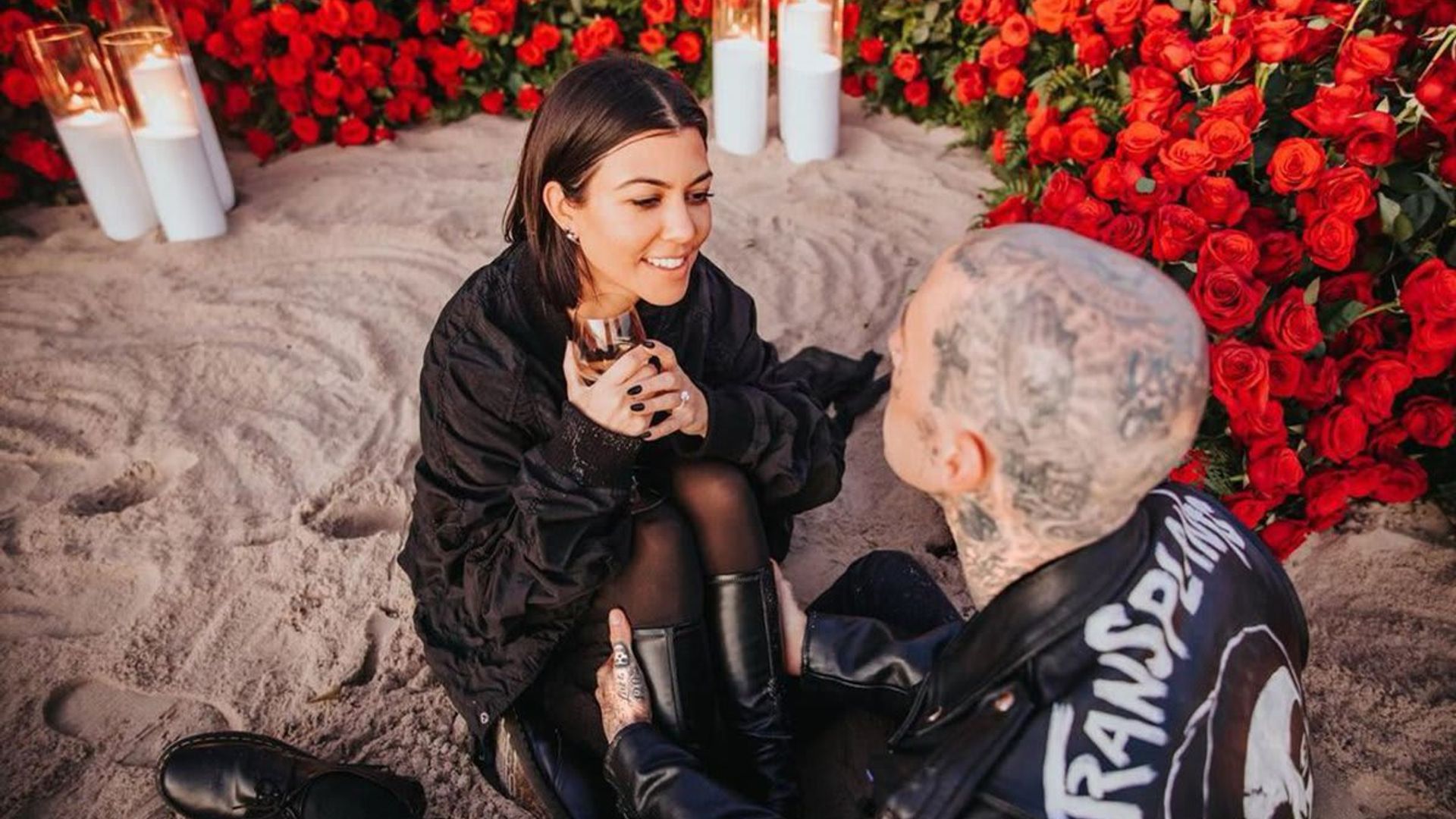 Kourtney Kardashian looks happier than ever as she lays on rose petals and shows off engagement ring