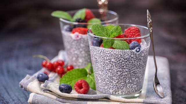 Chia seed pudding with fresh berries and mint topping for breakfast.