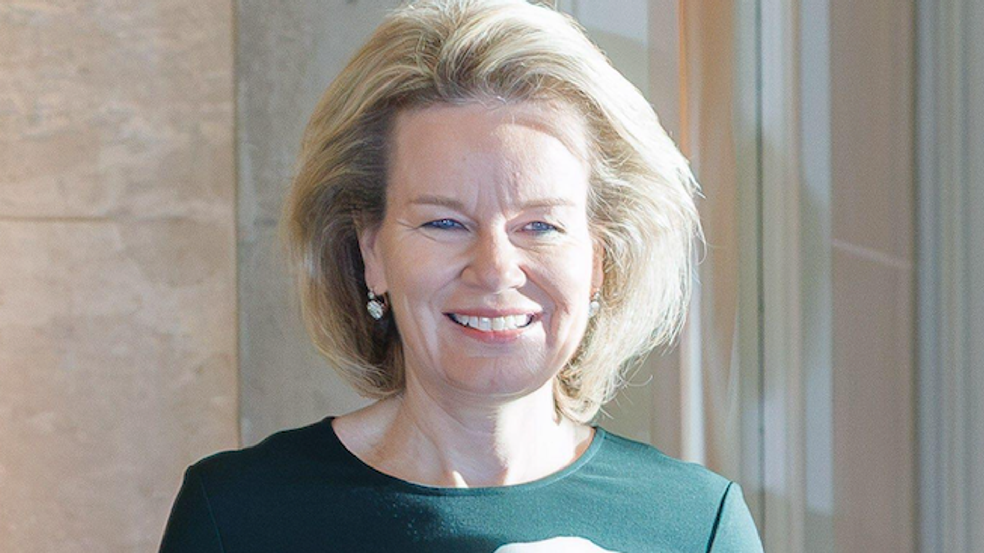 Queen Mathilde brings a romantic touch to fall fashion in a striking emerald-green dress
