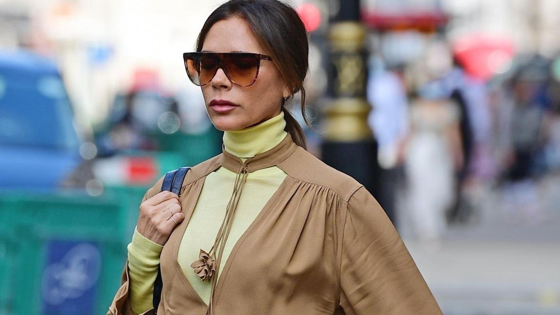 Victoria Beckham stuns in a monochromatic beige ensemble and blue suede stilettos