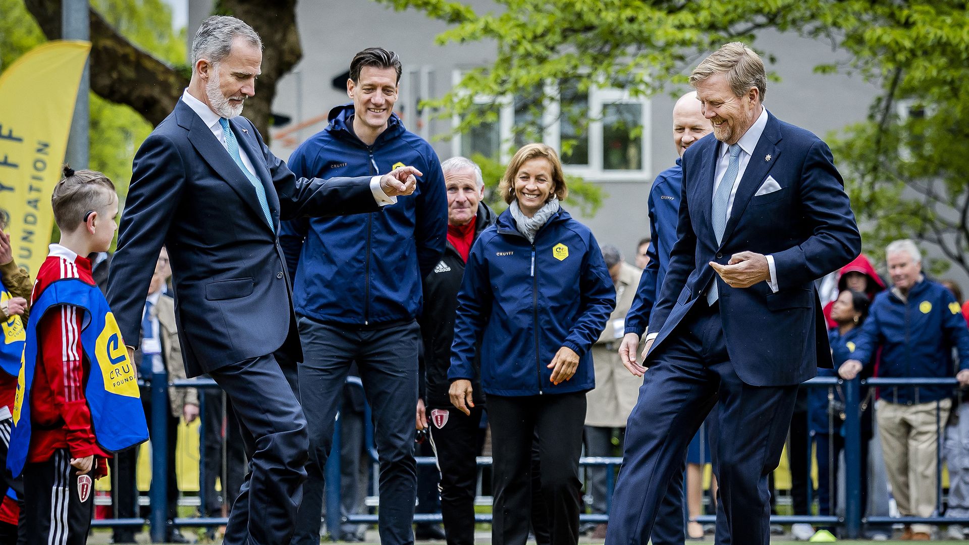 King Willem-Alexander of the Netherlands (R) and King Felipe of Spain (L) play football during a visit of the Johan Cruyff Sports Foundation as part of Spain's Royal couple's two-day state visit to the Netherlands, in Amsterdam on April 17, 2024