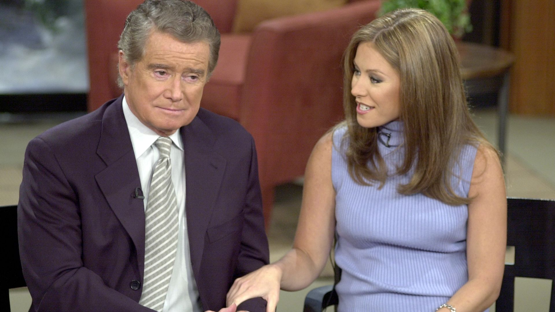Talk show host Regis Philbin and new co-host Kelly Ripa speak to the audience during a broadcast of "Live with Regis and Kelly."