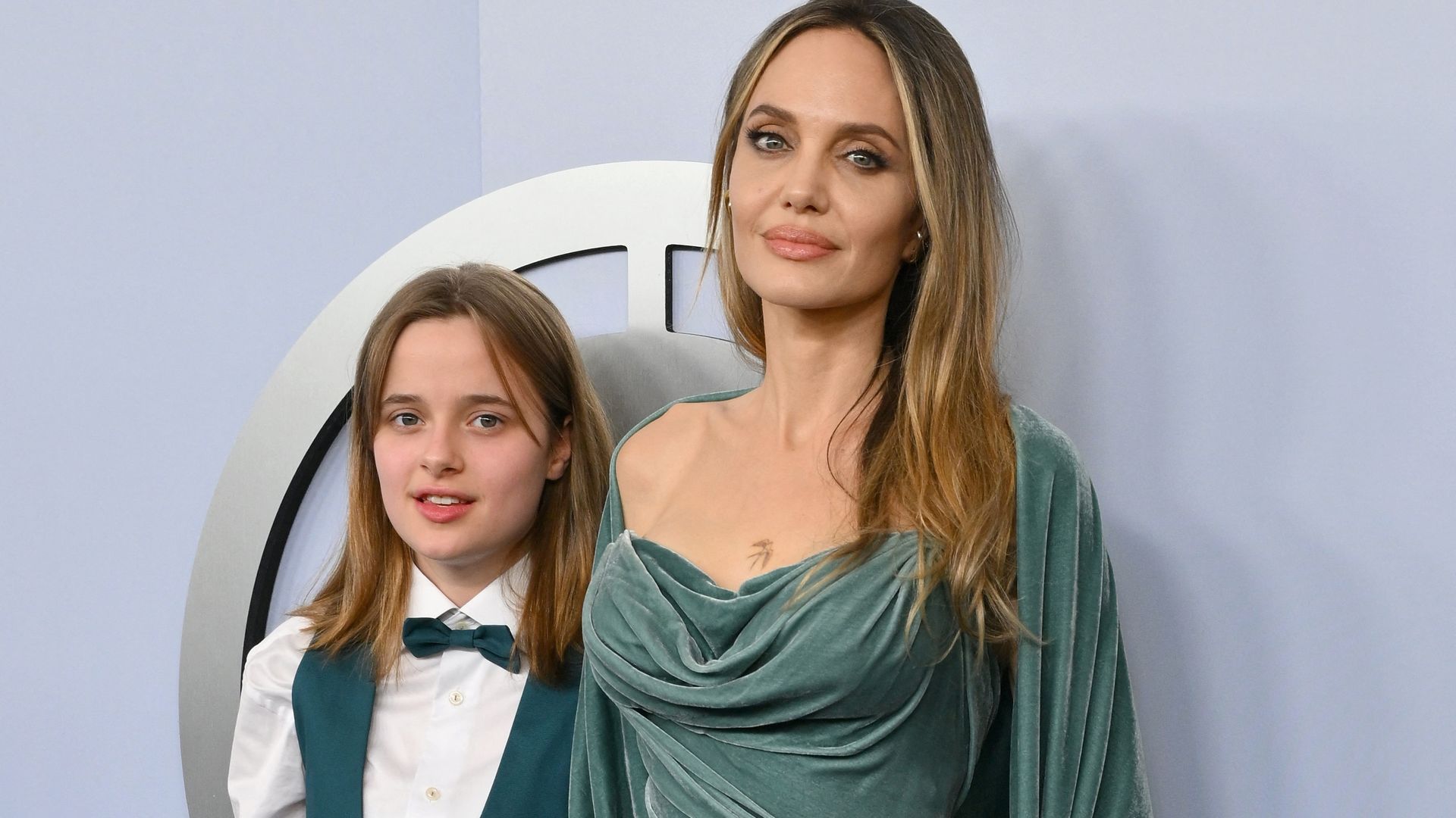 Angelina Jolie shows off chest tattoo with her daughter Vivienne by her side