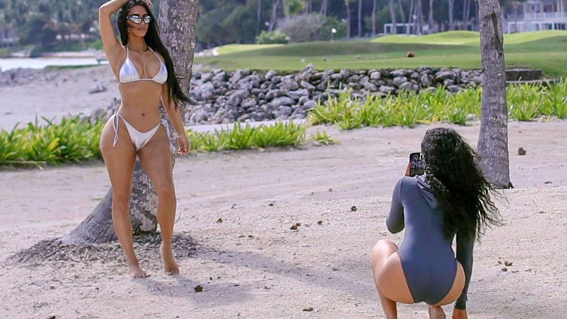 Kim Kardashian spotted while snapping stills in a shiny silver SKIMS bikini