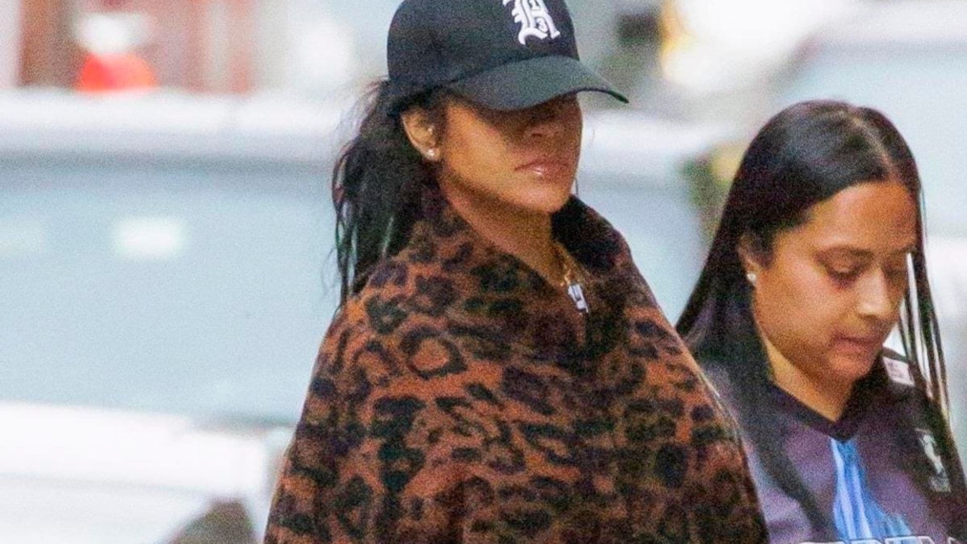 Rihanna shows off her growing baby bump in leopard print coat