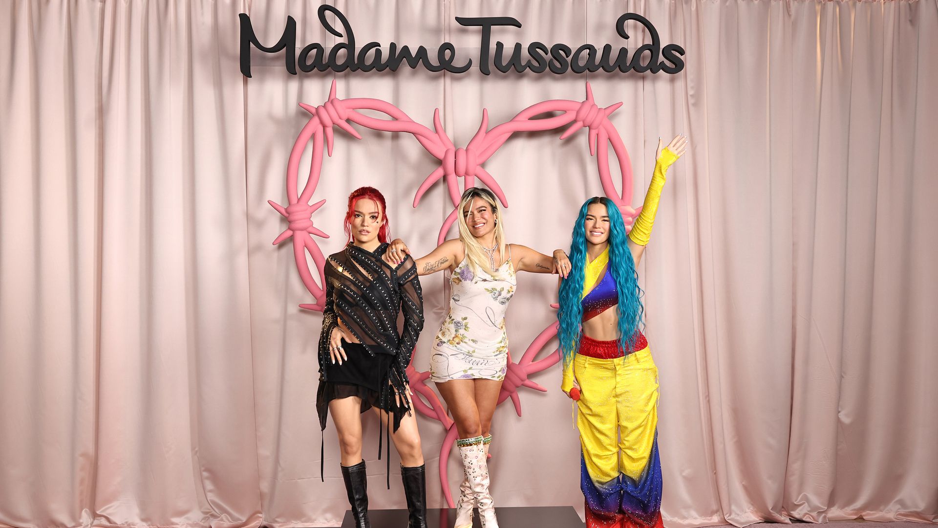 Karol G Strikes A Pose With Her Two New Wax Figures at Madame Tussauds on October 04, 2024, in New York City. (Photo by Jamie McCarthy/Getty Images for Madame Tussauds )