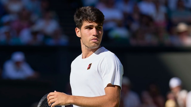 Carlos Alcaraz of Spain reacts in his 1st round men's singles match against Fabio Fognini of Italy on Centre Court during day one of The Championships Wimbledon 2025 at All England Lawn Tennis and Croquet Club on June 30, 2025 in London, England.