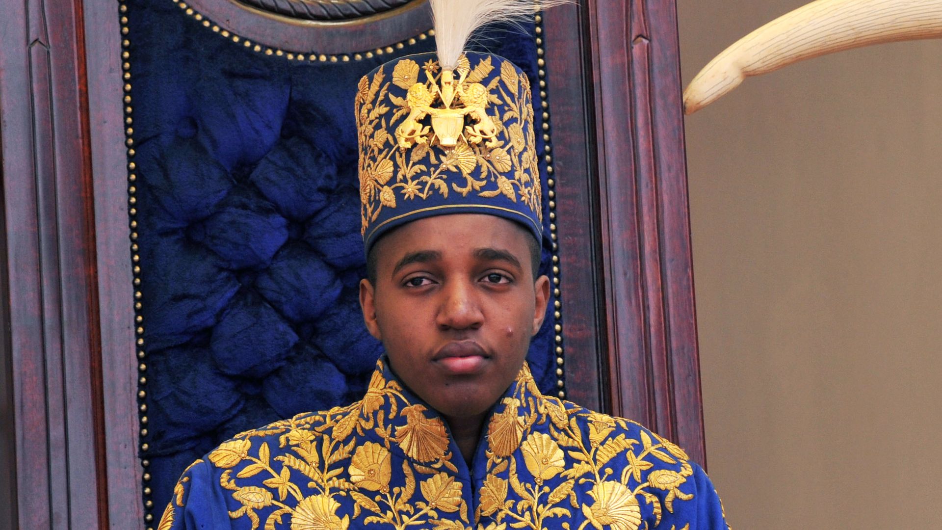 King Oyo Nyimba Kabamba Iguru Rukidi IV, 18, who was crowned as head of the Kingdom of Toro in a traditional ceremony in his hilltop palace overlooking his capital of Fort Portal sits on his throne on April 17, 2010