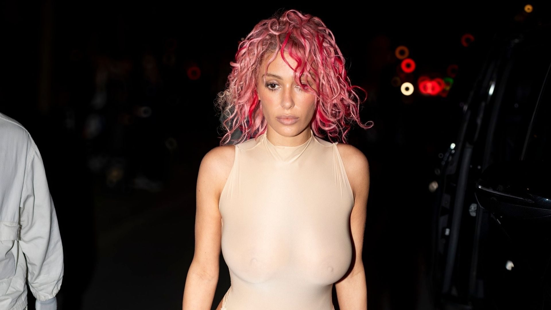 Bianca Censori steps out in sheer cut-out bodysuit and pink hair