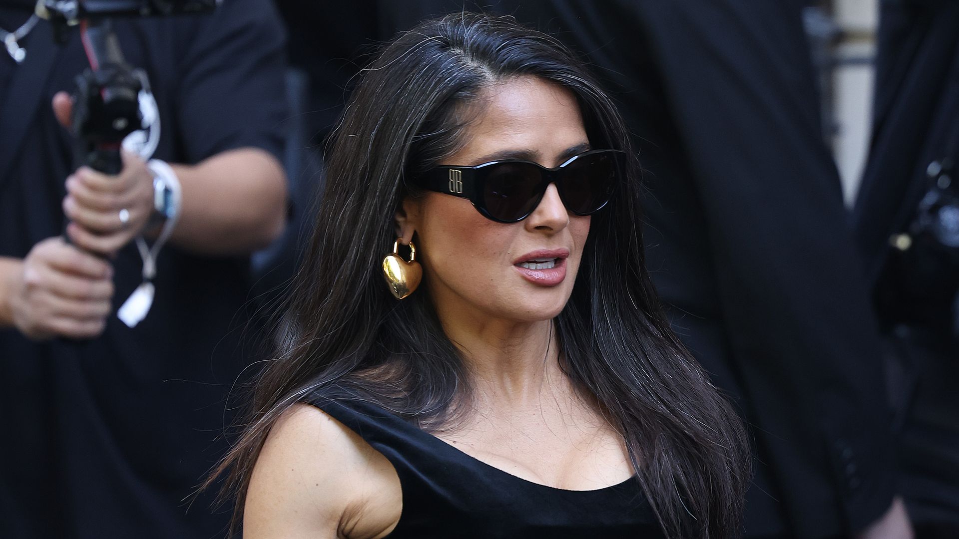 Salma Hayek posed in figure-hugging velvet dress and rocked her natural gray hair at Paris Fashion Week
