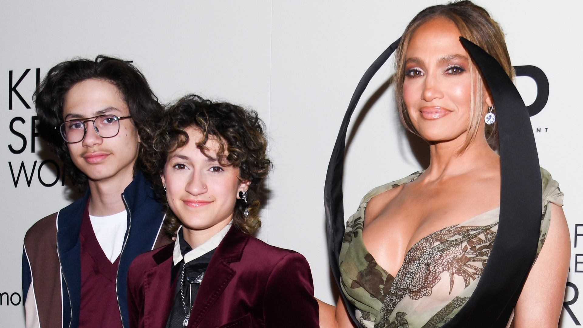 Jennifer Lopez steps out in a satin gown as son Max channels dad Marc Anthony in a colorful tee