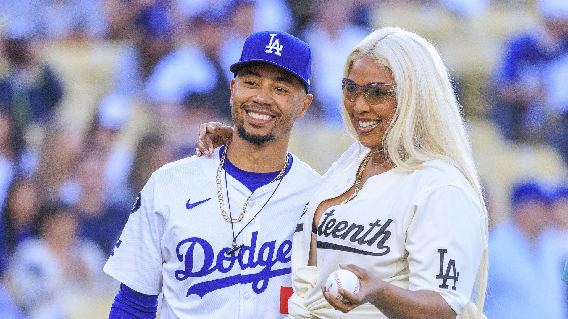 Lizzo throws the first pitch at a baseball game wearing heels and a Labubu keychain