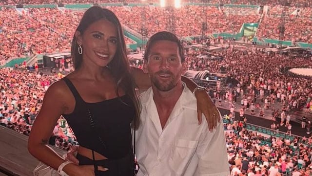 Lionel Messi blushes as he and Antonela Roccuzzo catch each other on the kiss cam at Coldplay's Miami concert