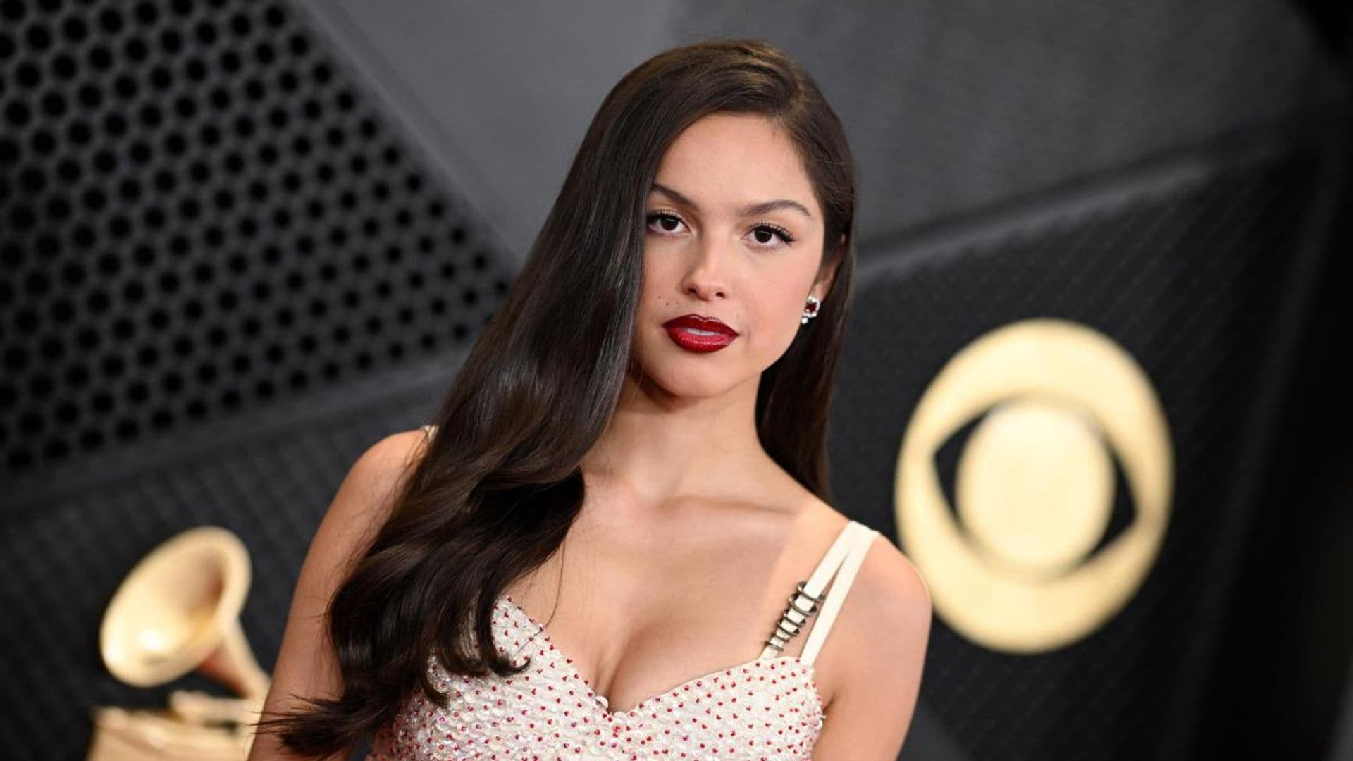 Olivia Rodrigo attends the Grammys wearing the Versace dress Linda Evangelista wore in 1995