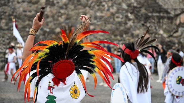 Members of indigenous communities take part in a ritual in front of the Pyramid of the Sun while celebrating the spring equinox at the Teotihuacan archaeological complex in Mexico City on March 20, 2025. (Photo by Yuri CORTEZ / AFP) (Photo by YURI CORTEZ/AFP via Getty Images)