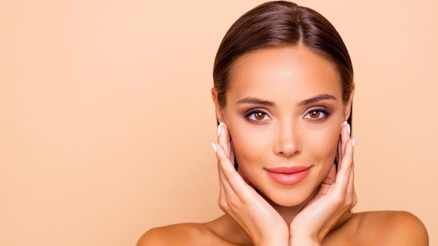 Woman with natural makeup and hair pulled back