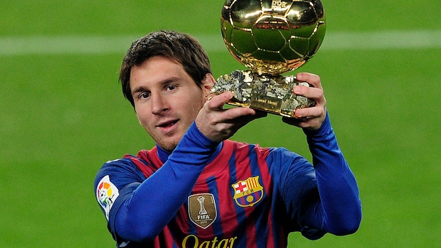 Lionel Messi poses with the 2011 Ballon d'Or on January 15, 2012 before the Spanish Cup football match opposing FC Barcelona to Real Betis at the Camp Nou stadium in Barcelona. AFP PHOTO/ JOSEP LAGO (Photo by JOSEP LAGO / AFP) (Photo by JOSEP LAGO/AFP via Getty Images)