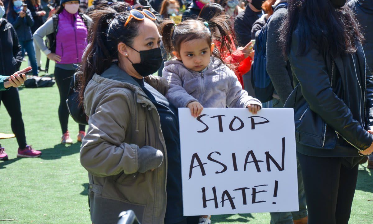 A young participant is seen holding a placard at Columbus