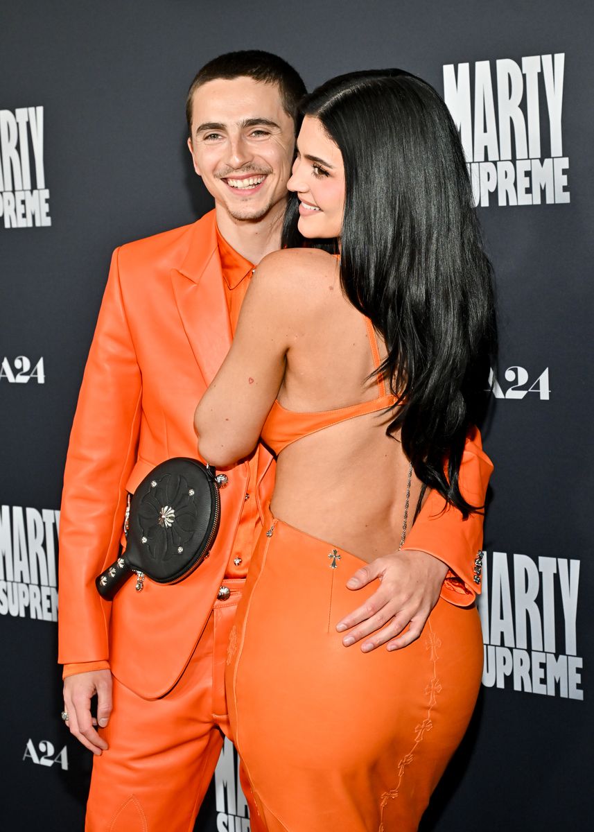 Timothée, 29, complemented her effortlessly in an orange leather suit and matching boots. 