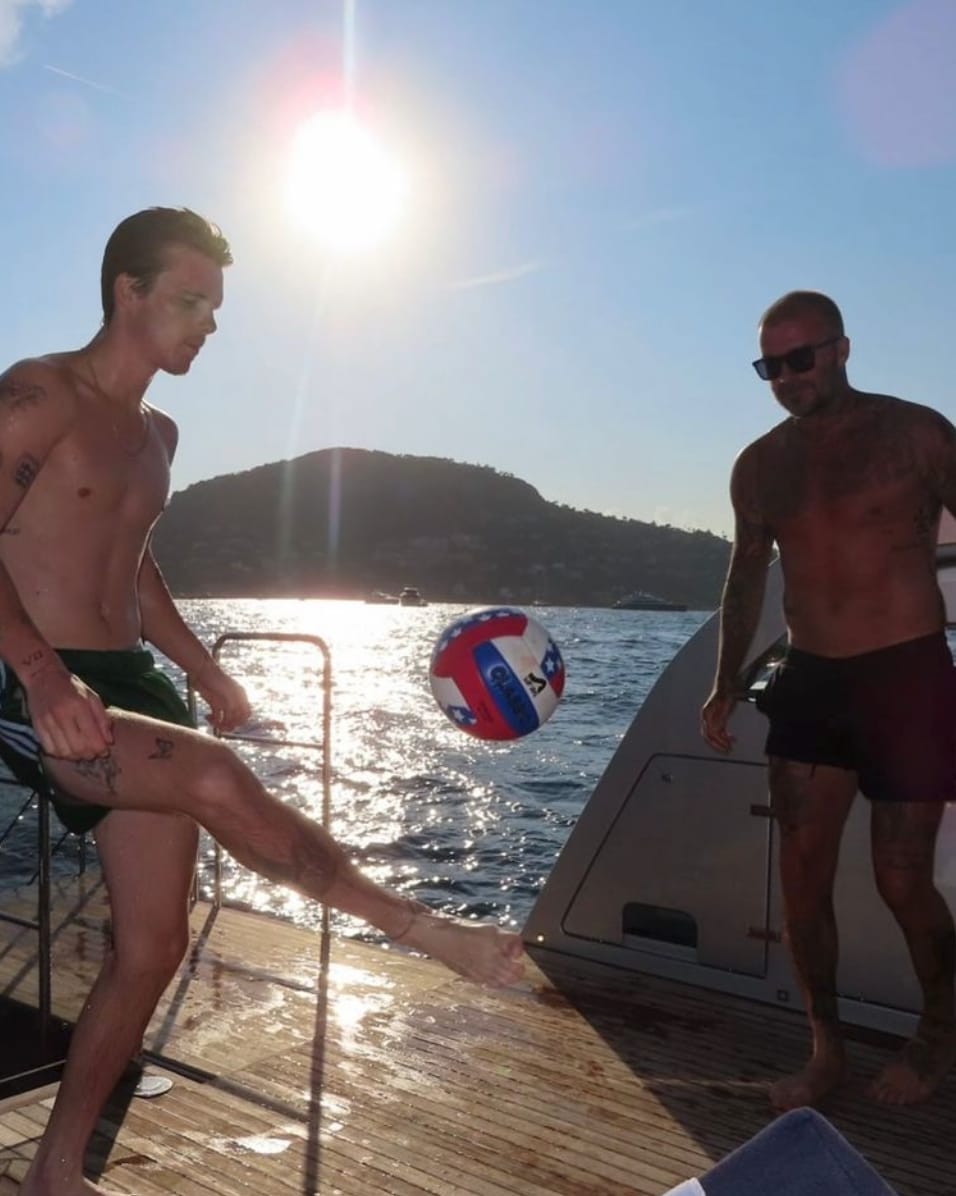 David and Cruz Beckham squeeze in a quick game of soccer on deck during their sun-soaked retreat
