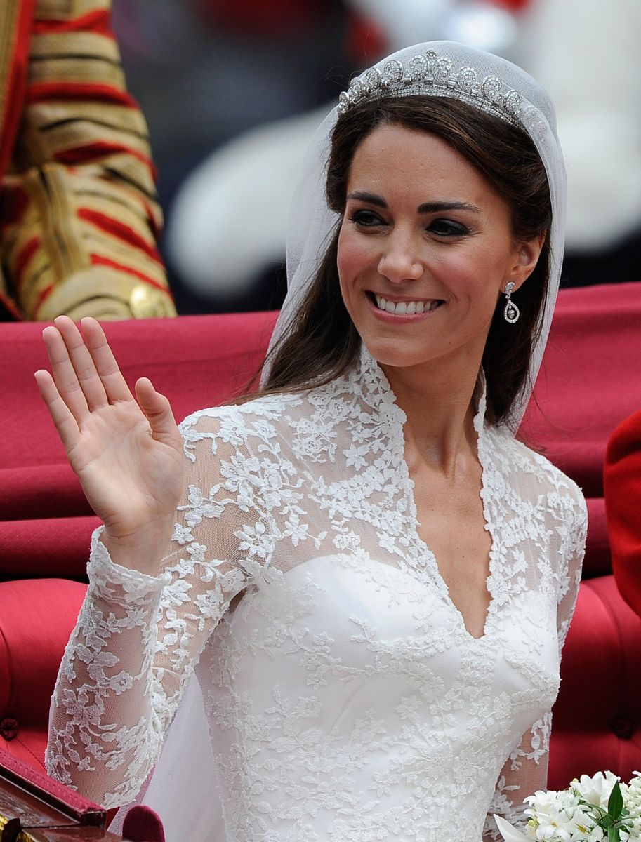LONDON, ENGLAND - APRIL 29:  Catherine, Duchess of Cambridge waves as she travels beside husband Prince William, Duke of Cambridge in the 1902 State Landau carriage on the procession route along The Mall to Buckingham Palace after their wedding ceremony at Westminster Abbey on April 29, 2011 in London, England. The marriage of the second in line to the British throne was led by the Archbishop of Canterbury and was attended by 1900 guests, including foreign Royal family members and heads of state. Thousands of well-wishers from around the world have also flocked to London to witness the spectacle and pageantry of the Royal Wedding.  (Photo by Paul Hackett - WPA Pool/Getty Images)