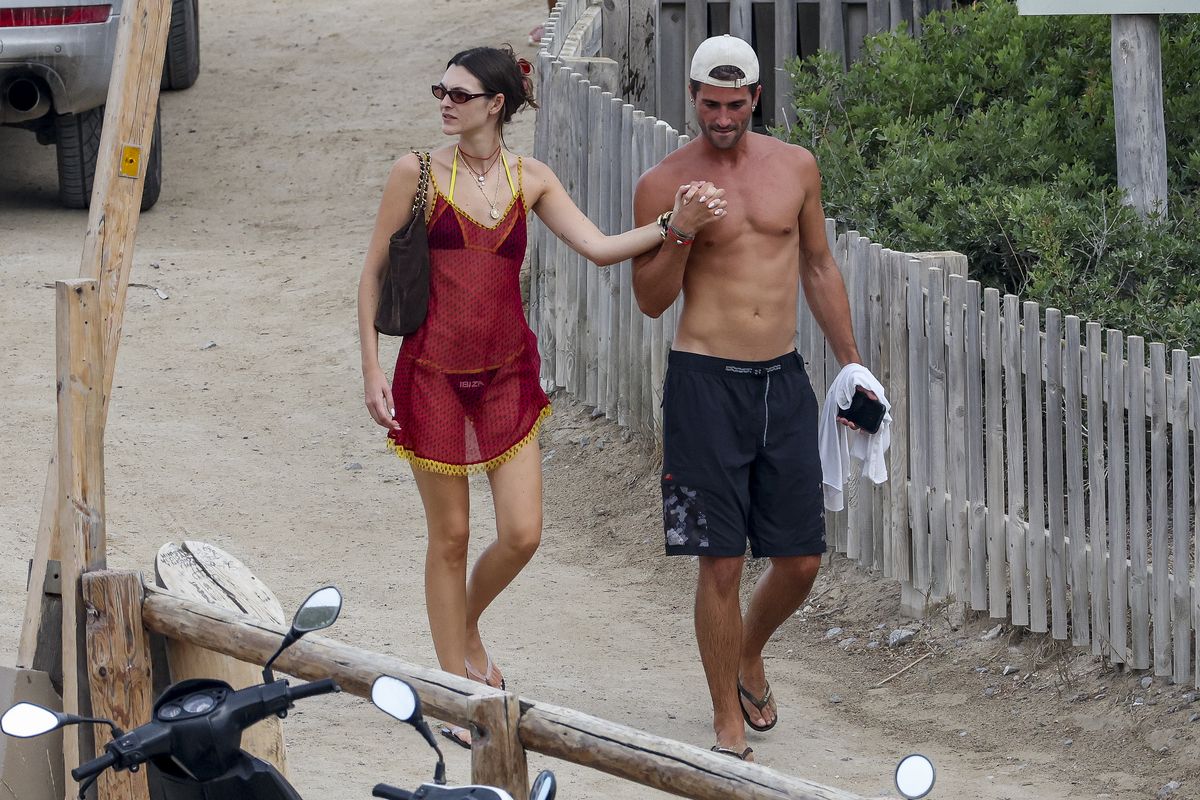 Vittoria Ceretti and Marc Forné leave a beachside restaurant in Ibiza after dining with friends, including Leonardo DiCaprio.