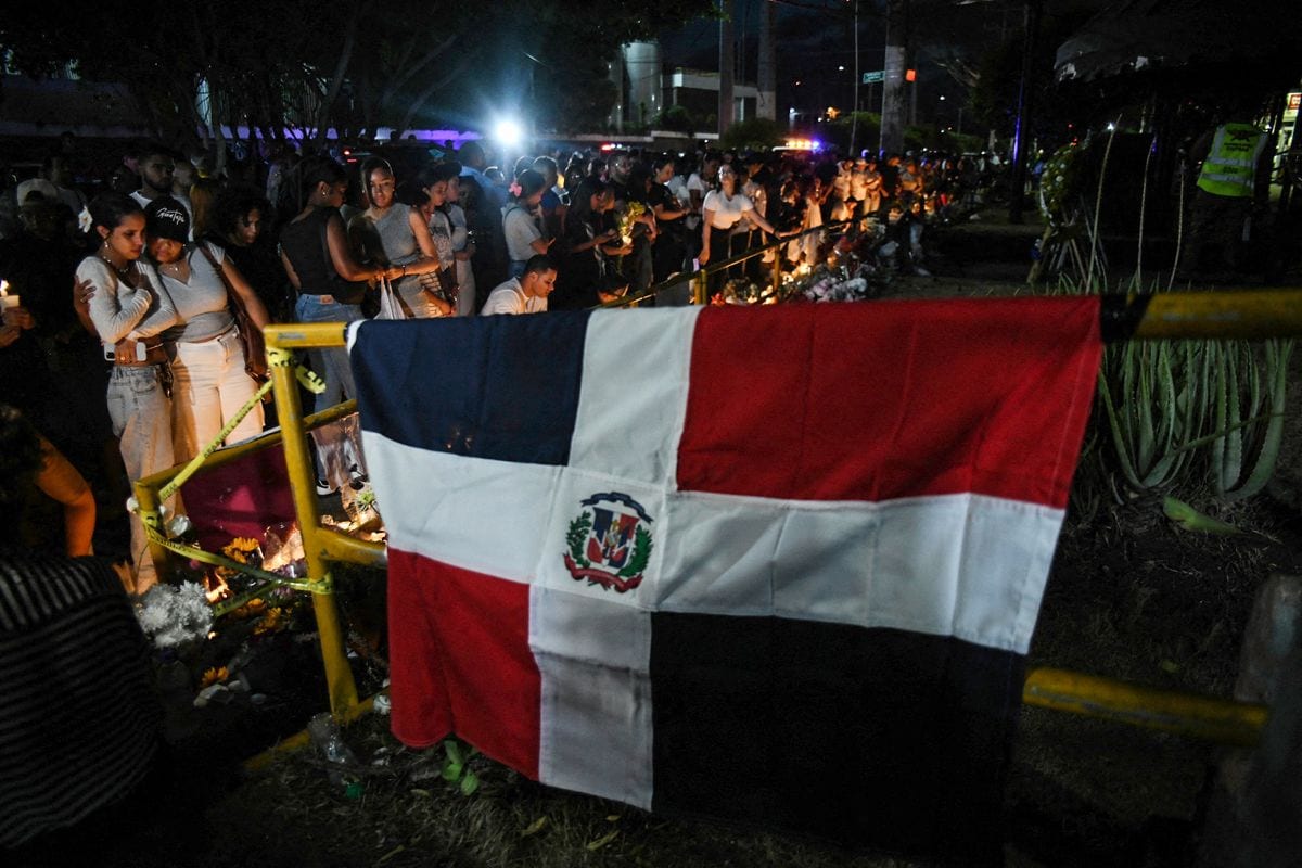 Friends and relatives light candles as they pay tribute to the victims in front of the Jet Set nightclub in Santo Domingo on April 12, 2025. 