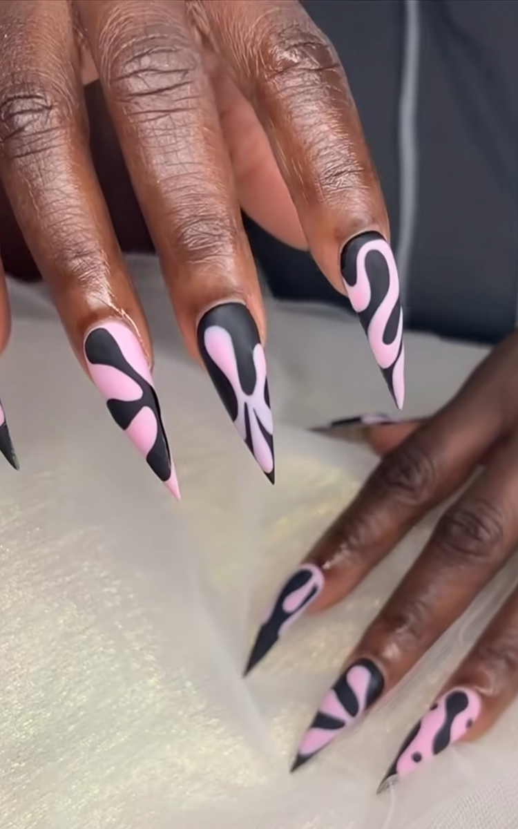 These retro-inspired nails featuring a wave effect are equal parts Y2K and modern art. The dramatic stiletto shape is paired with a playful abstract swirl design in matte black and soft bubblegum pink. The matte finish gives the bold color contrast a velvety, high-fashion look, which is unapologetically bold with a cool-girl editorial energy.