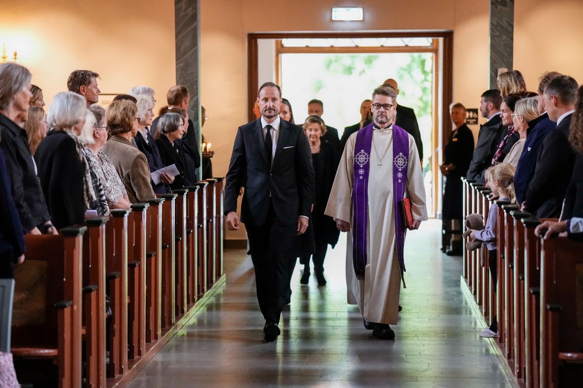 Norway's King Haakon VIII accompanied by Dean Oyvind Stabrun and followed by Crown Princess Ingrid Alexandra, Queen Sonja and Prince Sverre Magnus, walks down the aisle to attend a memorial church service for the late King Harald V at Asker Church.