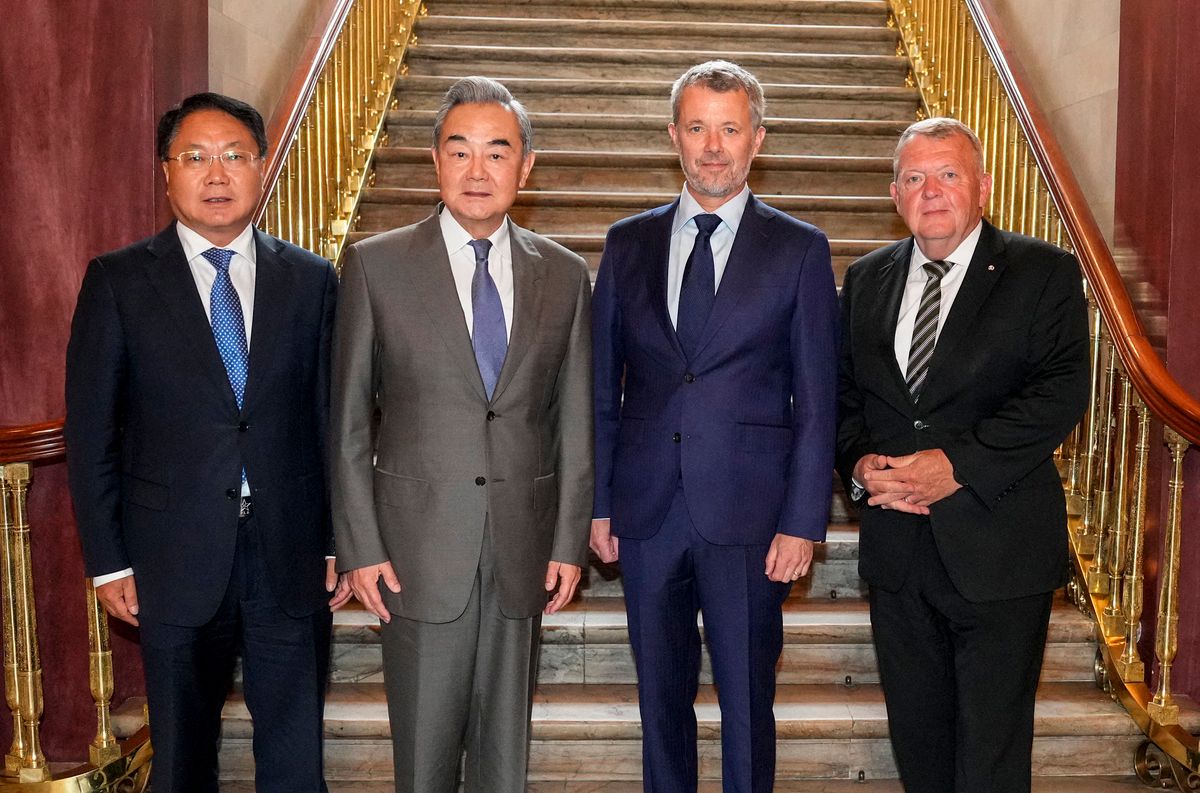 China's Ambassador to Denmark Wang Xuefeng, Chinese Foreign Minister Wang Yi, King Frederik X, and Danish Foreign Minister Lars Løkke Rasmussen pose during an official audience at Amalienborg Palace in Copenhagen.